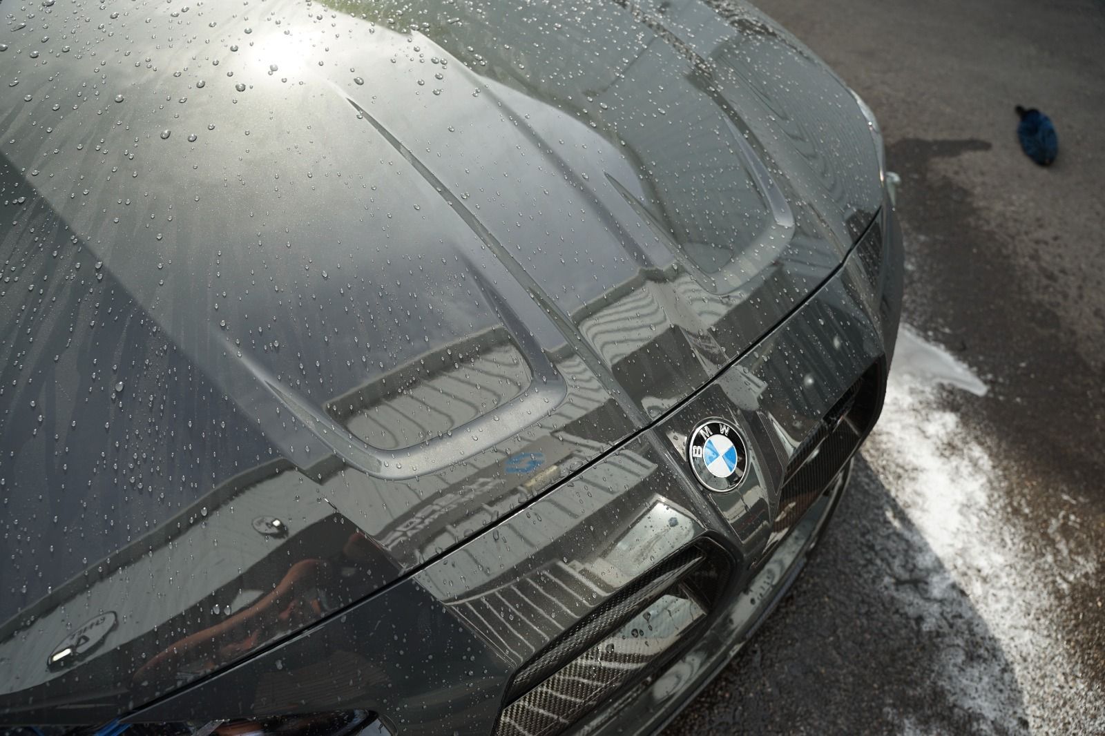 Mechanic carrying out a pre-purchase inspection under a bonnet