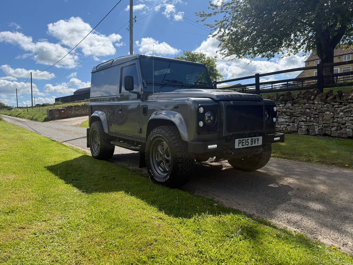 A grey Defender 90 on a Yorkshire country lane