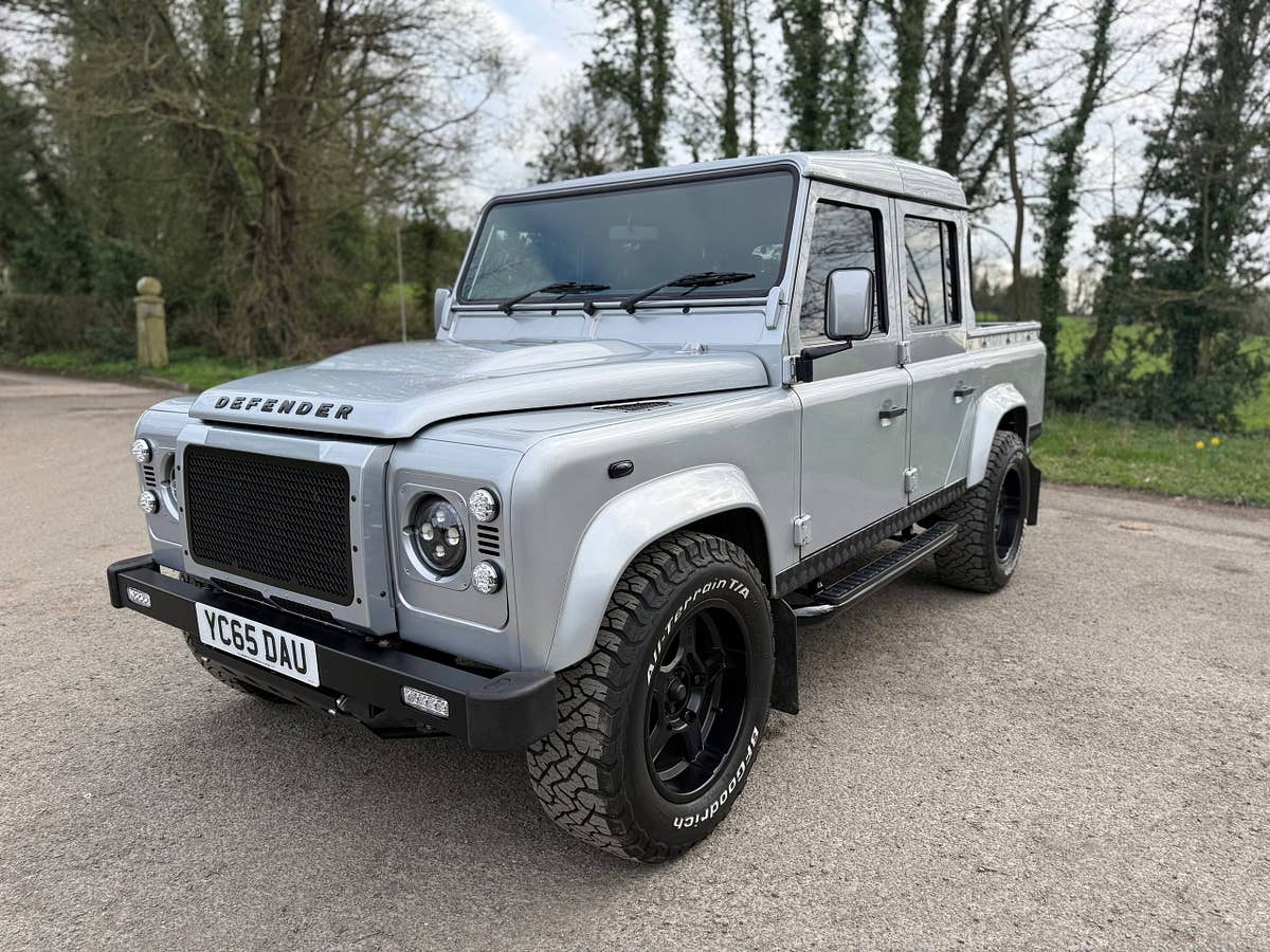 A silver Defender 110 double-cab pickup prepared and ready for collection