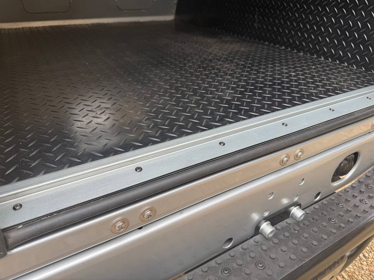 Chequer-plate load bed and tailgate detail on a prepared Defender