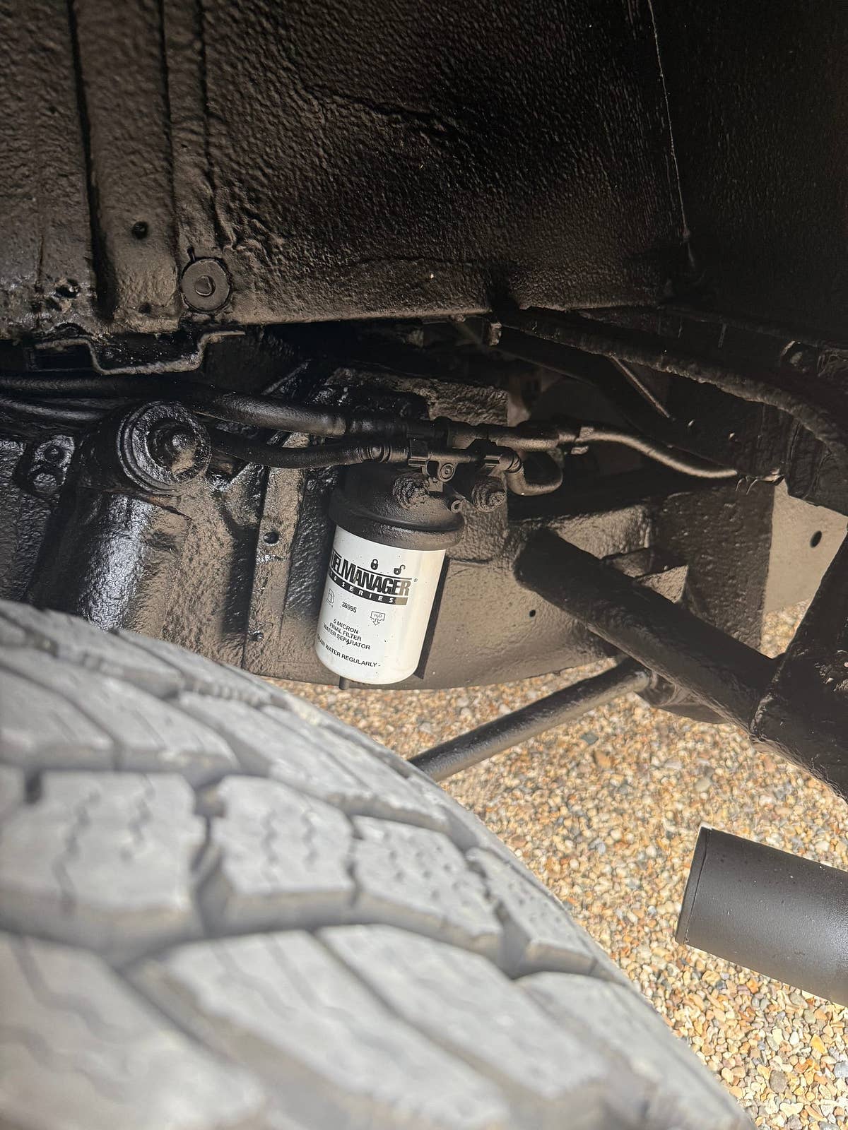 The underside of a prepared Defender, showing the chassis rail and oil filter