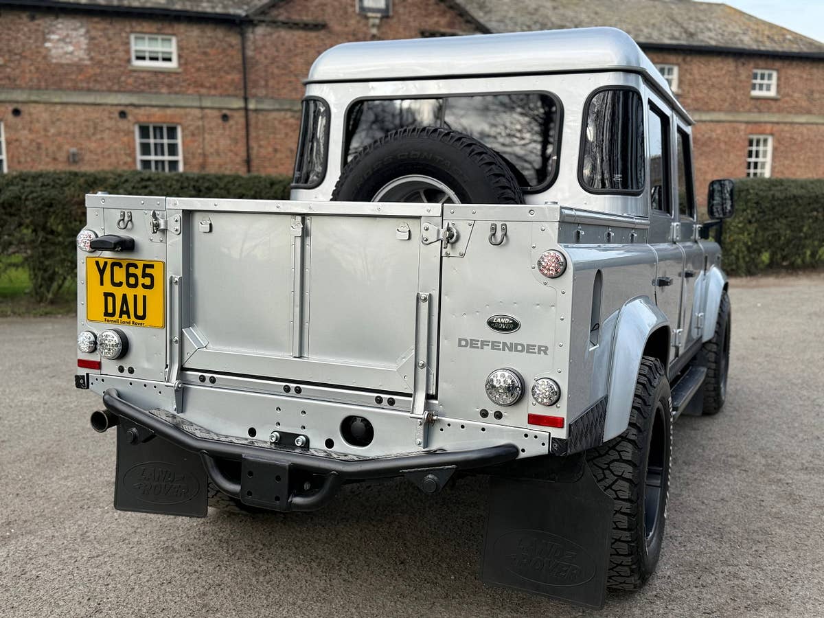 A silver Defender 110 double-cab pickup prepared for collection